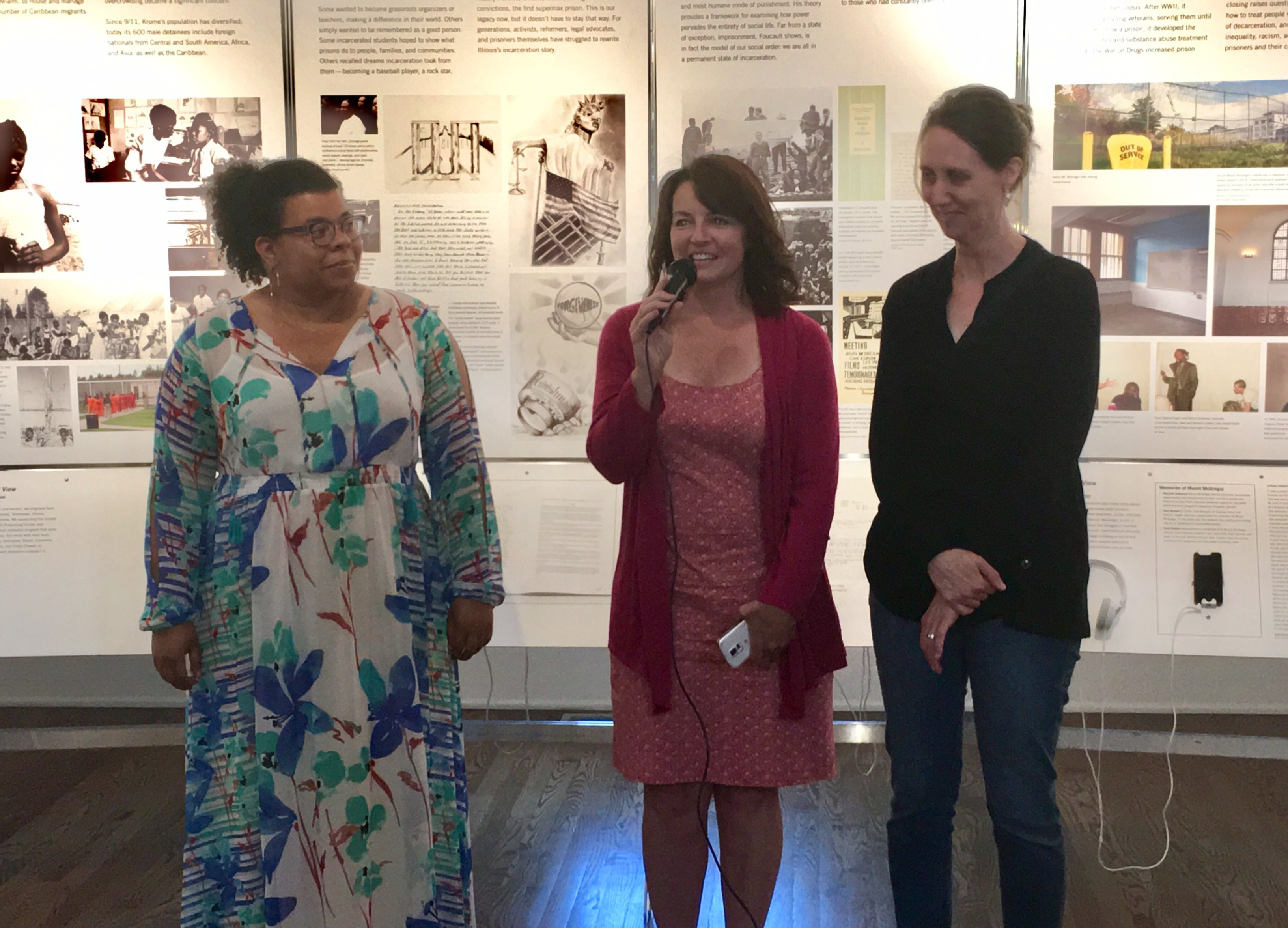 Three women standing in front of the States of Incarceration exhibit.