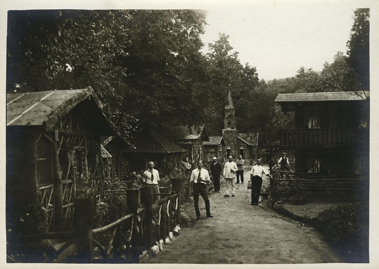 Photograph of German nationals standing outside residential dwellings. 